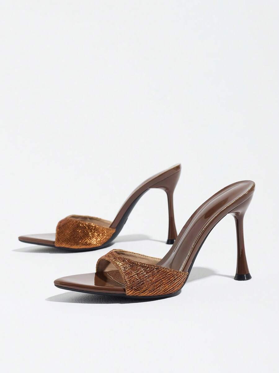 Women's coffee brown high heel mule shoes featuring a glossy mirror finish, open toe design, and sleek stiletto heel.
