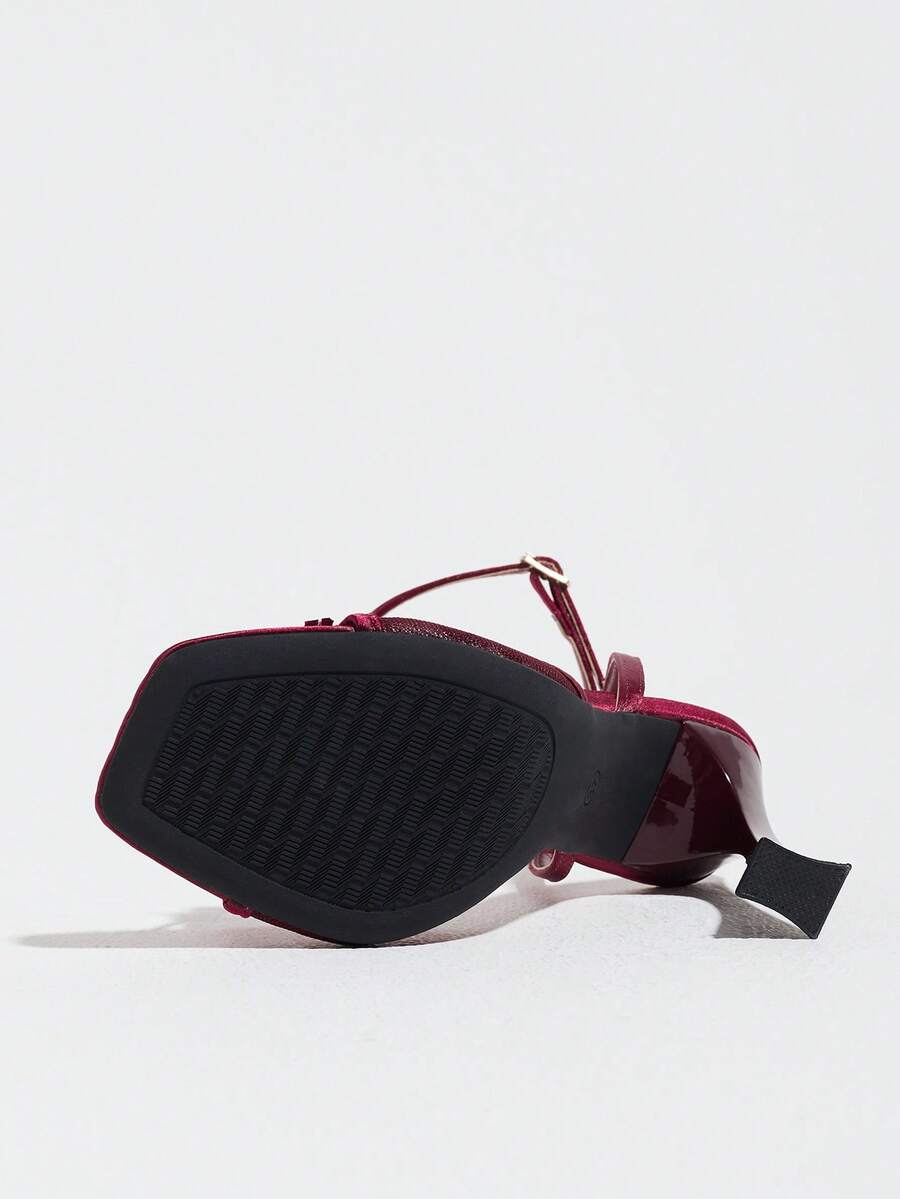 Burgundy women's square toe high heel sandals featuring a mesh bow accent and ankle strap buckle on an open toe silhouette