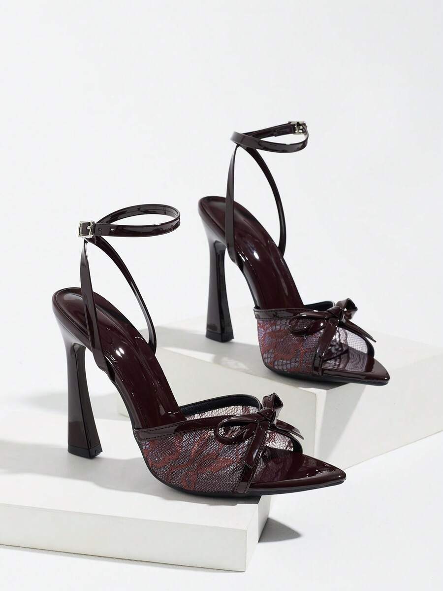 Burgundy open-toe high heels featuring an adjustable ankle strap with buckle closure and high stiletto heel.