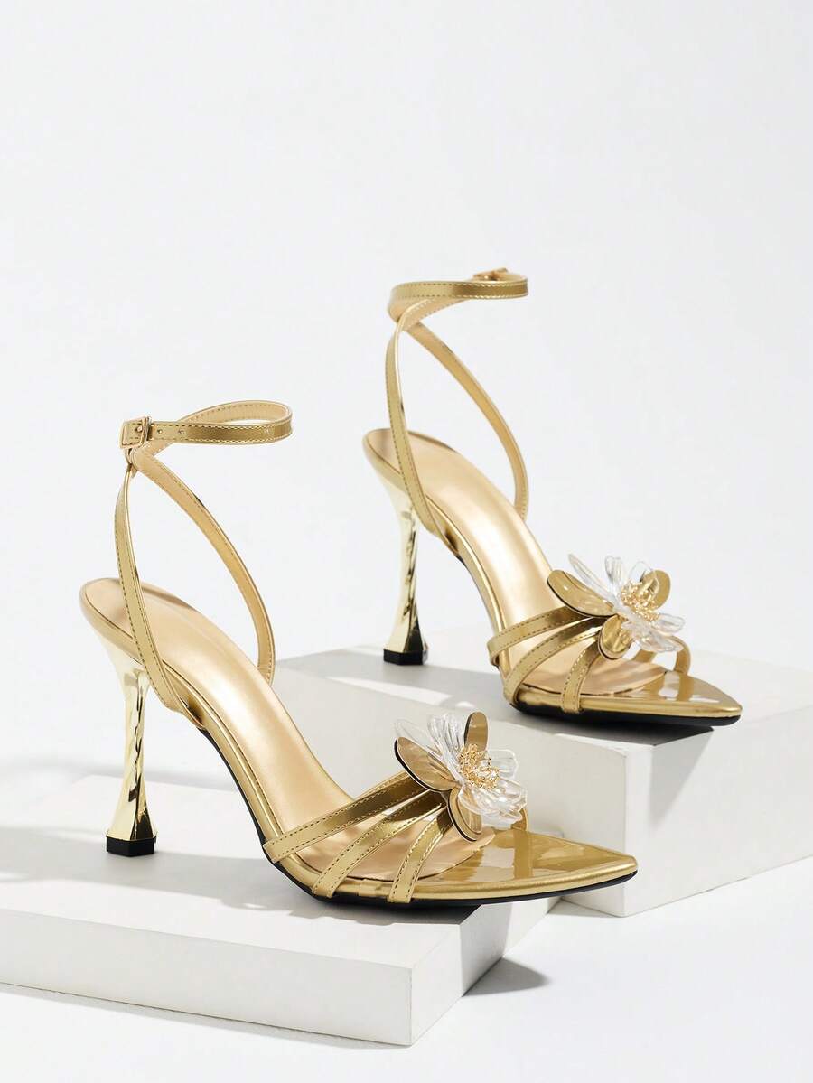 Women's black open toe stiletto heel sandals featuring lace mesh detailing, wide strap styling, and high stiletto heels.