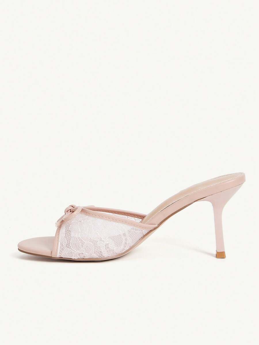Open toe high heel slide sandals featuring lace details and a bow accent on the upper strap.
