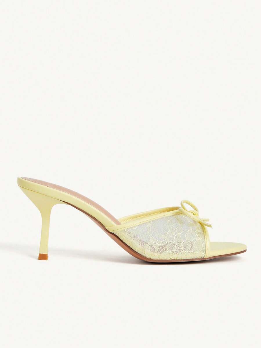 Open toe high heel slide sandals featuring lace details and a bow accent on the upper strap.