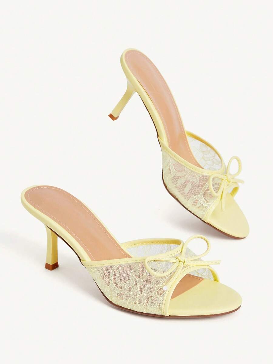 Open toe high heel slide sandals featuring lace details and a bow accent on the upper strap.