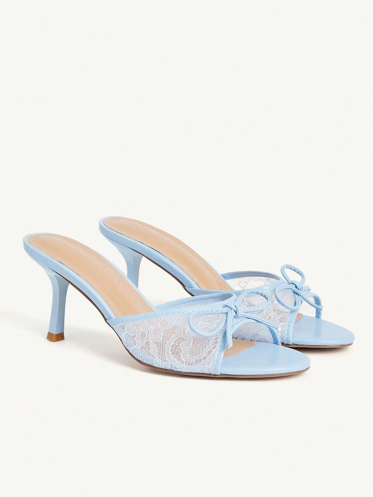Open toe high heel slide sandals featuring lace details and a bow accent on the upper strap.