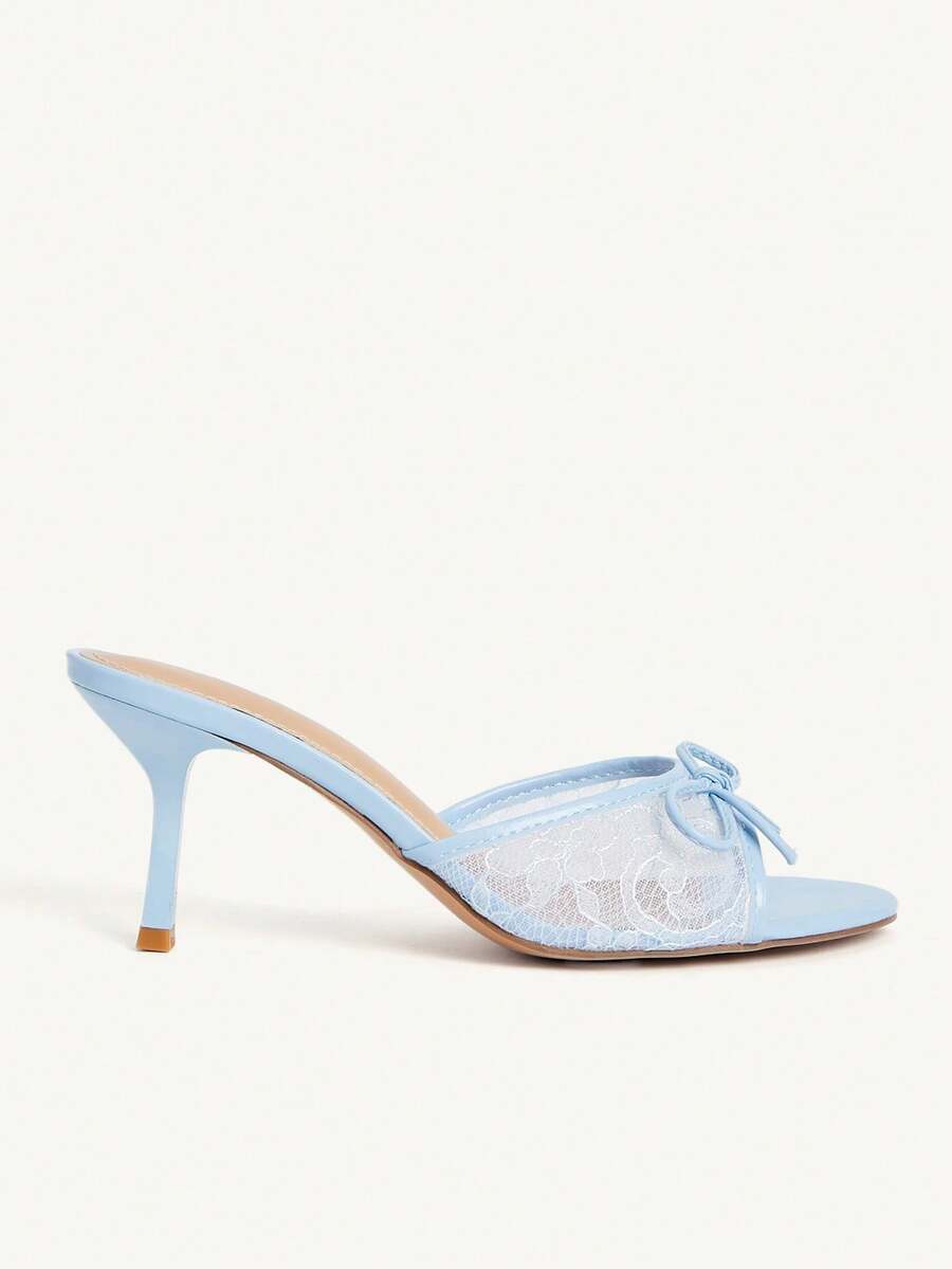 Open toe high heel slide sandals featuring lace details and a bow accent on the upper strap.
