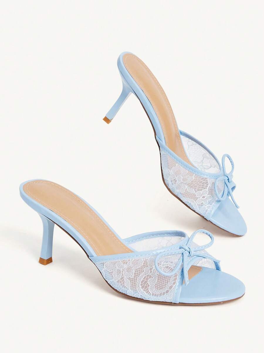 Open toe high heel slide sandals featuring lace details and a bow accent on the upper strap.