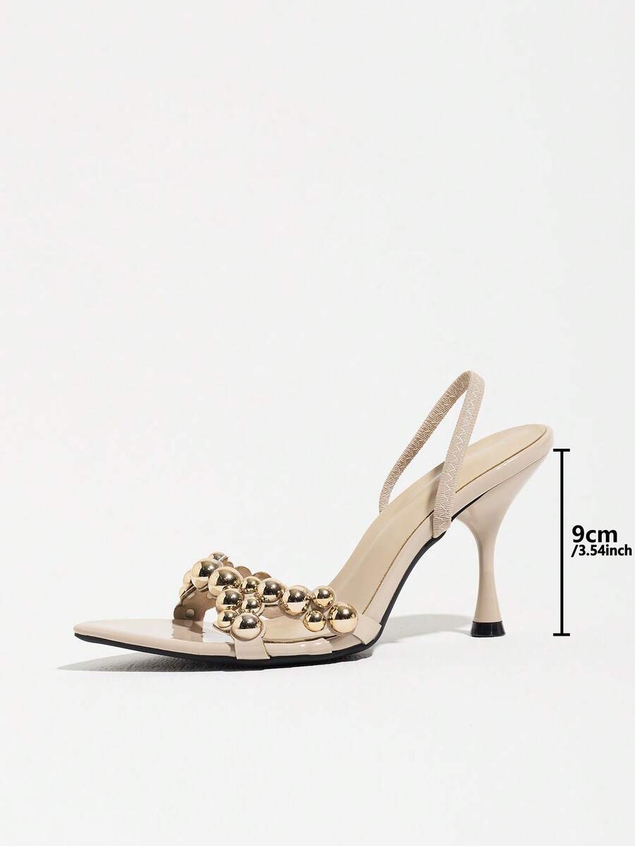 Pointed toe party high heels in gold featuring wavy lace trim, a stiletto heel, and back tie slingback straps.