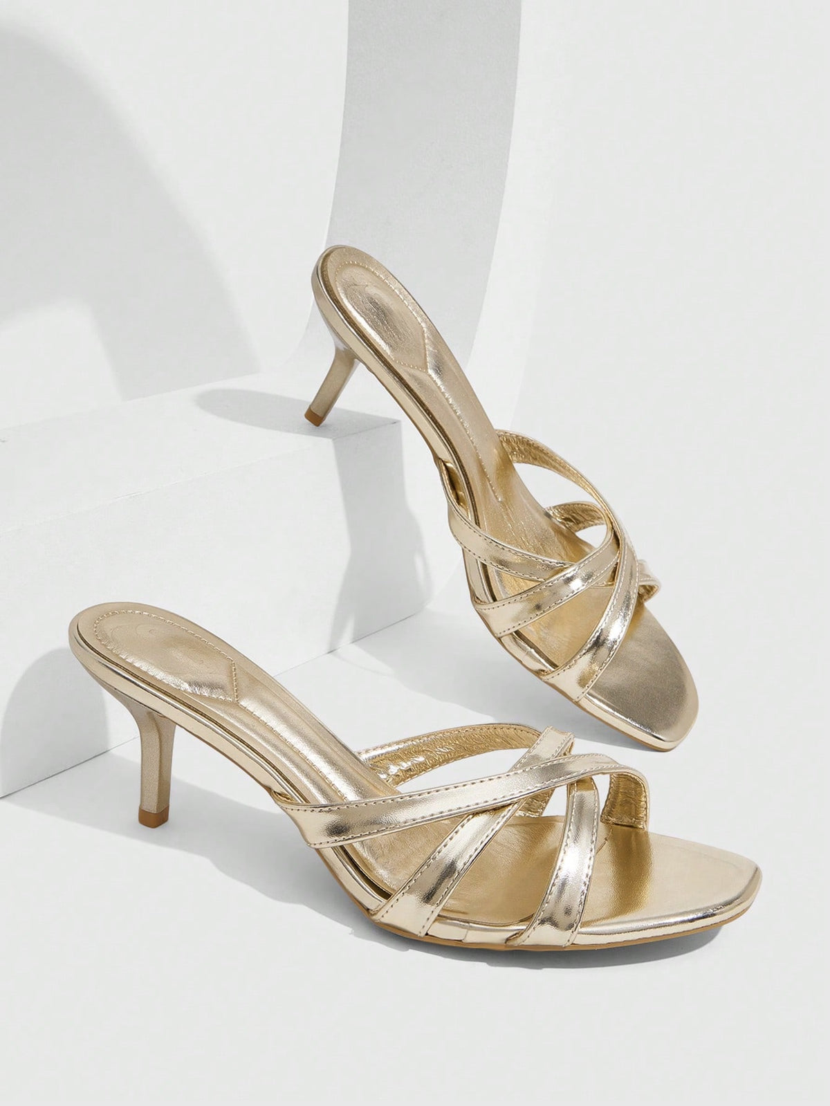 Square toe gold metallic heel sandals for women featuring open toe, crossover slingback strap, and stiletto mid heel for weddings and parties.