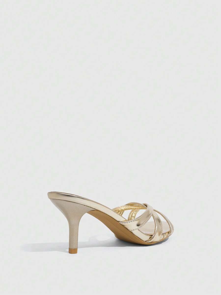 Square toe gold metallic heel sandals for women featuring open toe, crossover slingback strap, and stiletto mid heel for weddings and parties.