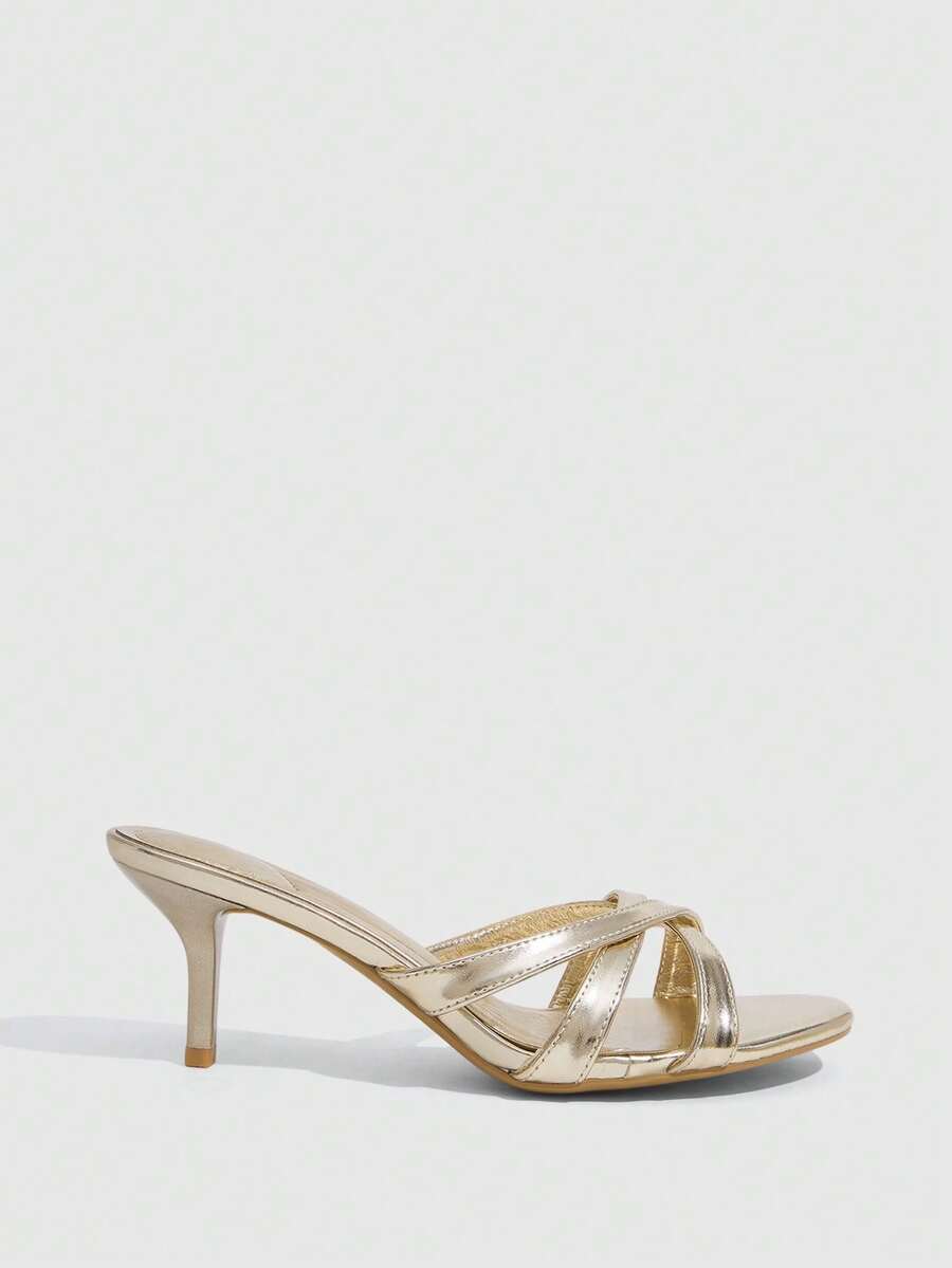 Square toe gold metallic heel sandals for women featuring open toe, crossover slingback strap, and stiletto mid heel for weddings and parties.