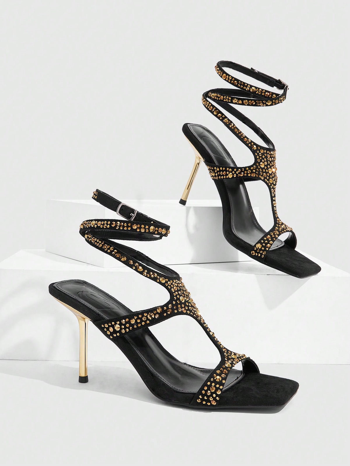 Square toe stiletto sandals featuring rhinestone straps, open toe design, and ankle wrap closures.