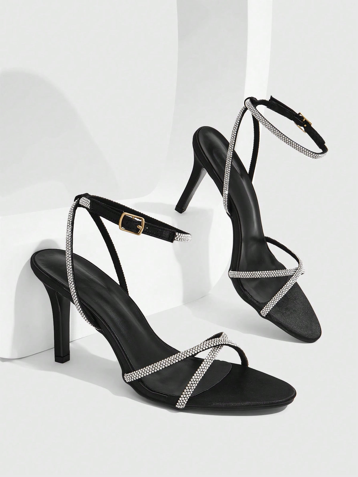 Women's open toe stiletto heel sandals featuring square toe design, criss-cross rhinestone slim straps, and secure ankle strap.