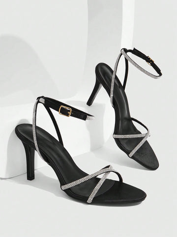Women's open toe stiletto heel sandals featuring square toe design, criss-cross rhinestone slim straps, and secure ankle strap.