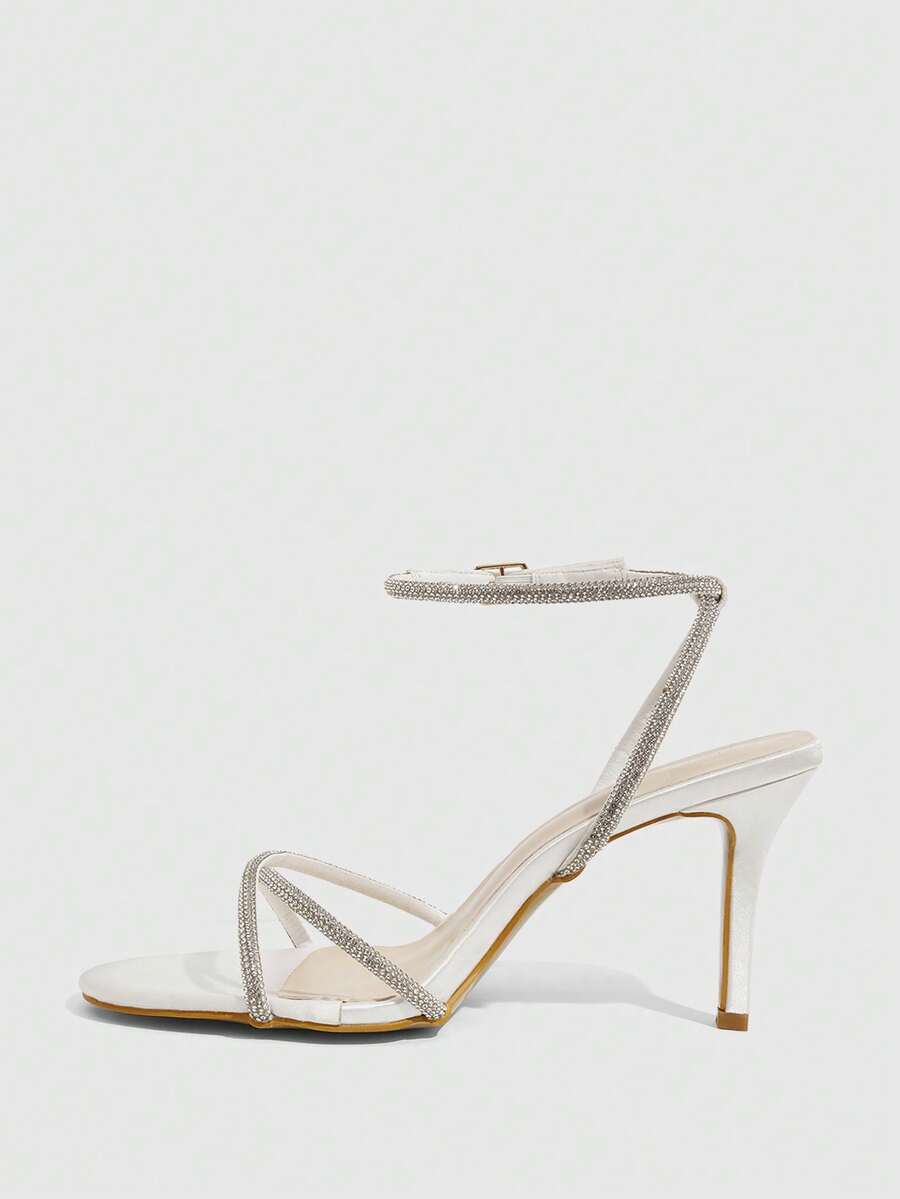 Women's open toe stiletto heel sandals featuring square toe design, criss-cross rhinestone slim straps, and secure ankle strap.