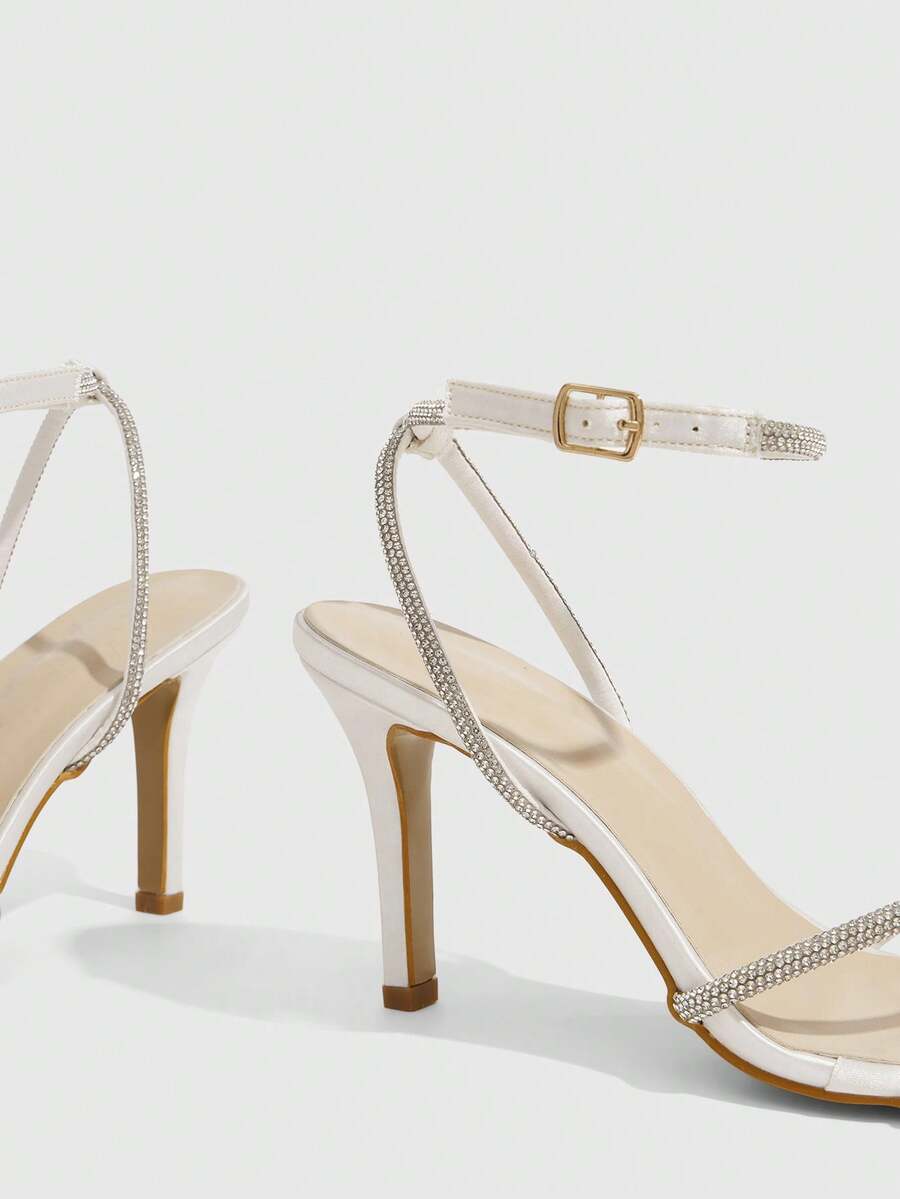 Women's open toe stiletto heel sandals featuring square toe design, criss-cross rhinestone slim straps, and secure ankle strap.