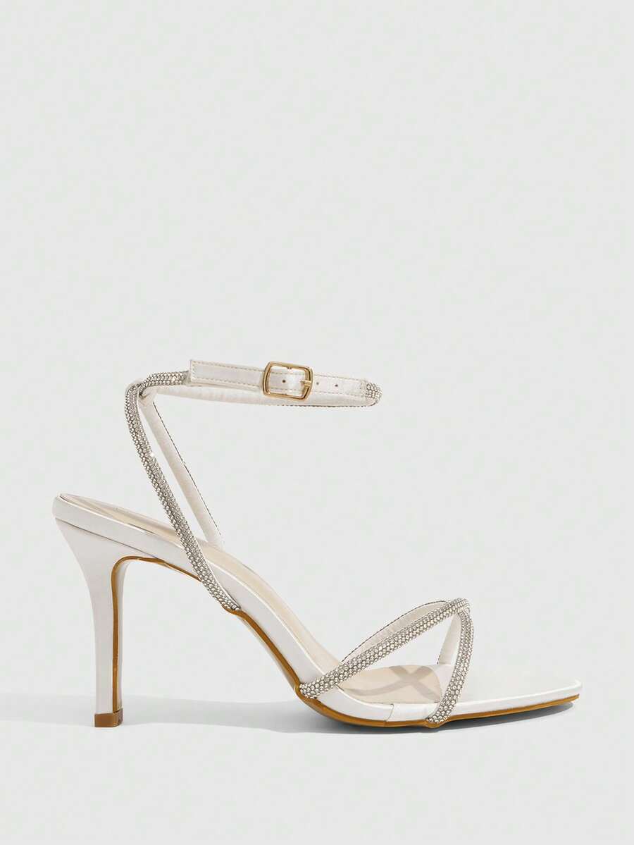 Women's open toe stiletto heel sandals featuring square toe design, criss-cross rhinestone slim straps, and secure ankle strap.