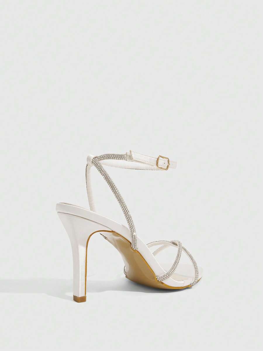 Women's open toe stiletto heel sandals featuring square toe design, criss-cross rhinestone slim straps, and secure ankle strap.