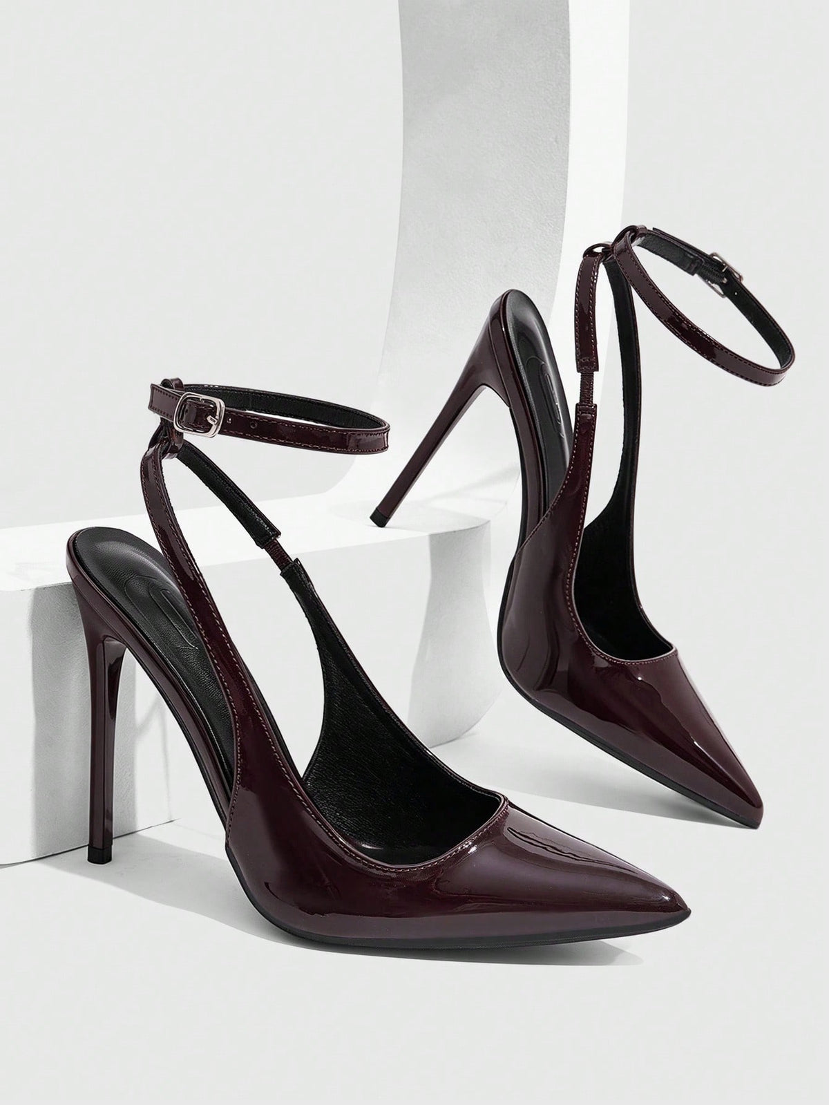 Pointed toe stiletto high heels with slingback silhouette and adjustable buckle ankle strap.
