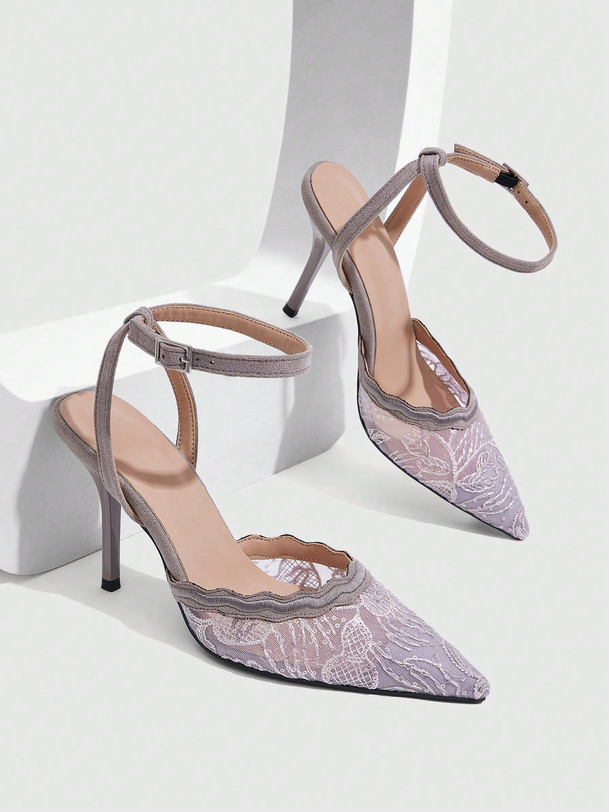 Women's stiletto high heel shoes featuring an elegant buckle detail and ankle strap slingback design.