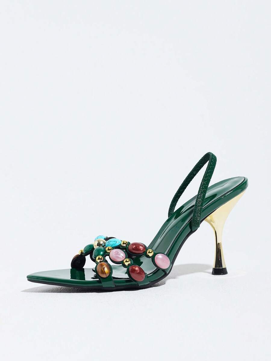 Pointed toe party high heels in gold featuring wavy lace trim, a stiletto heel, and back tie slingback straps.