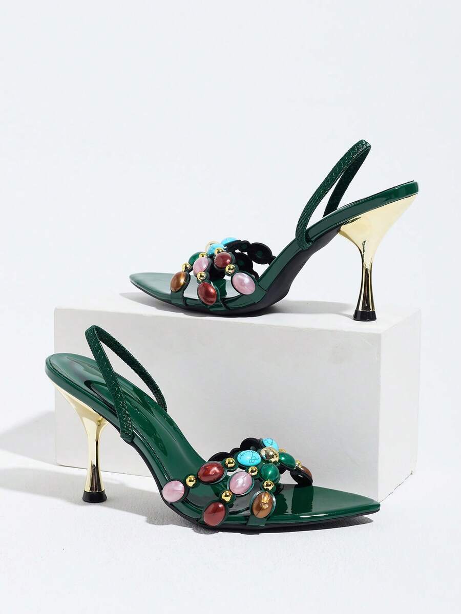 Pointed toe party high heels in gold featuring wavy lace trim, a stiletto heel, and back tie slingback straps.