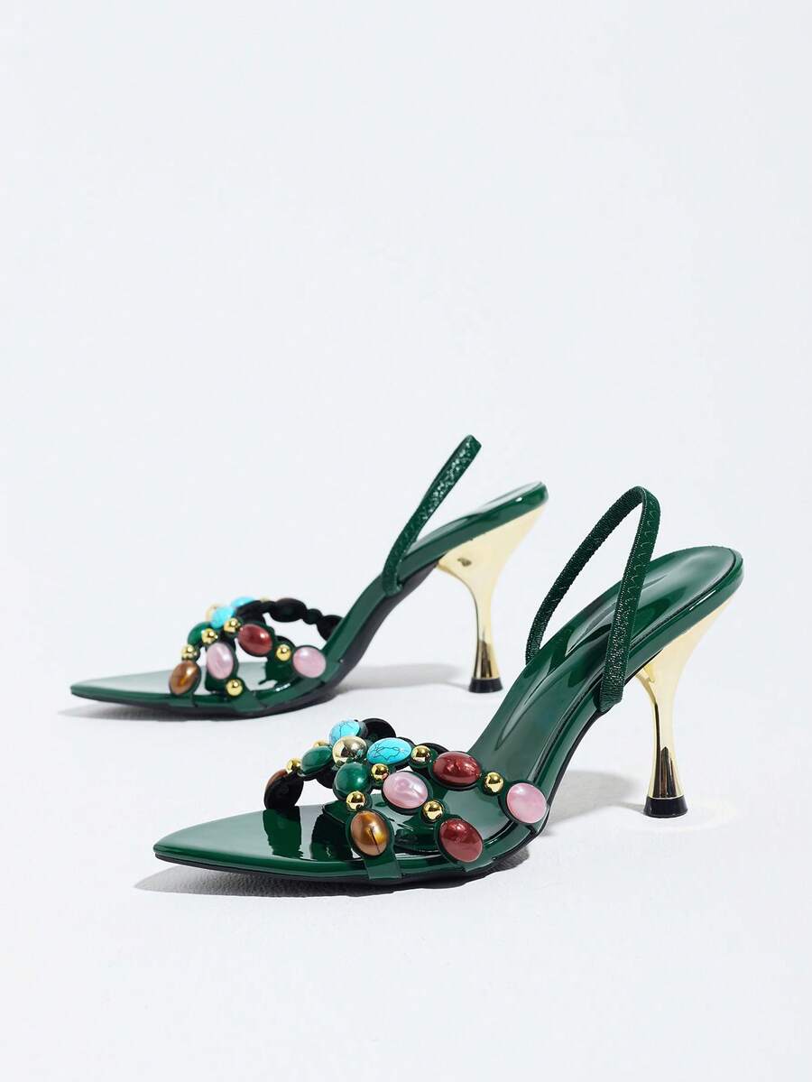 Pointed toe party high heels in gold featuring wavy lace trim, a stiletto heel, and back tie slingback straps.