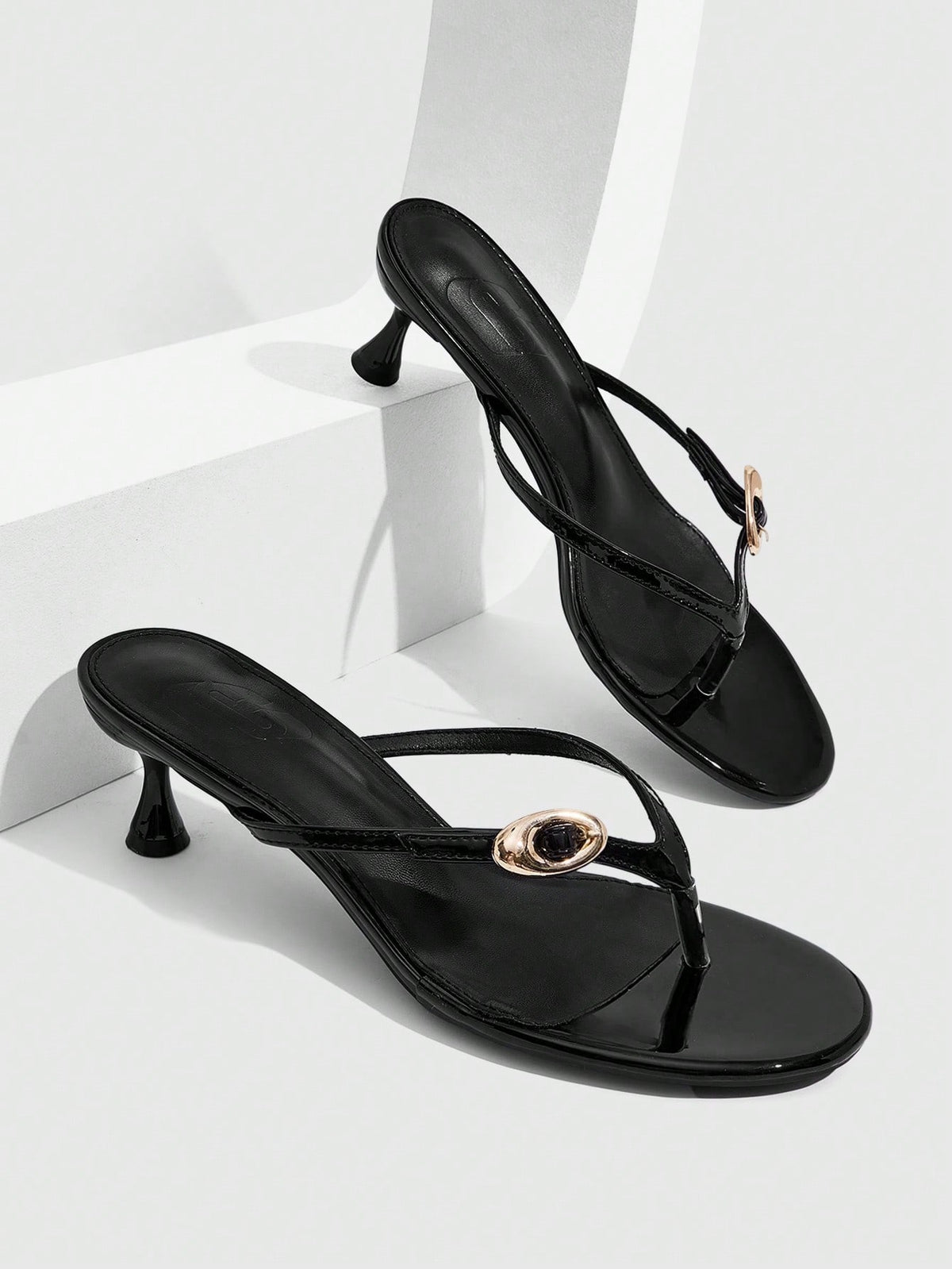 Women's slingback heeled sandals featuring a button toe post accent, sleek mid pyramid heel, and smooth faux leather finish.
