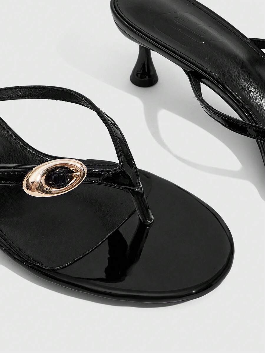 Women's slingback heeled sandals featuring a button toe post accent, sleek mid pyramid heel, and smooth faux leather finish.