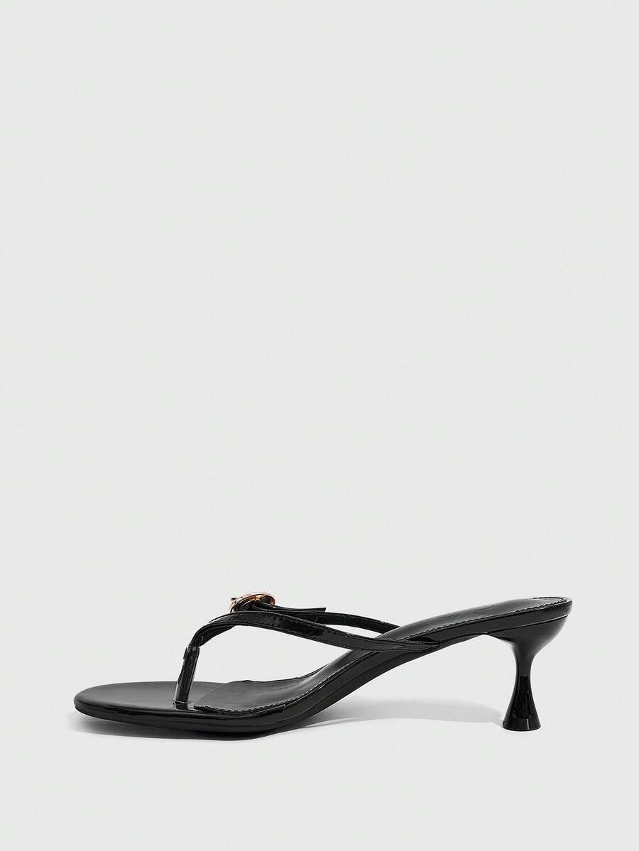 Women's slingback heeled sandals featuring a button toe post accent, sleek mid pyramid heel, and smooth faux leather finish.