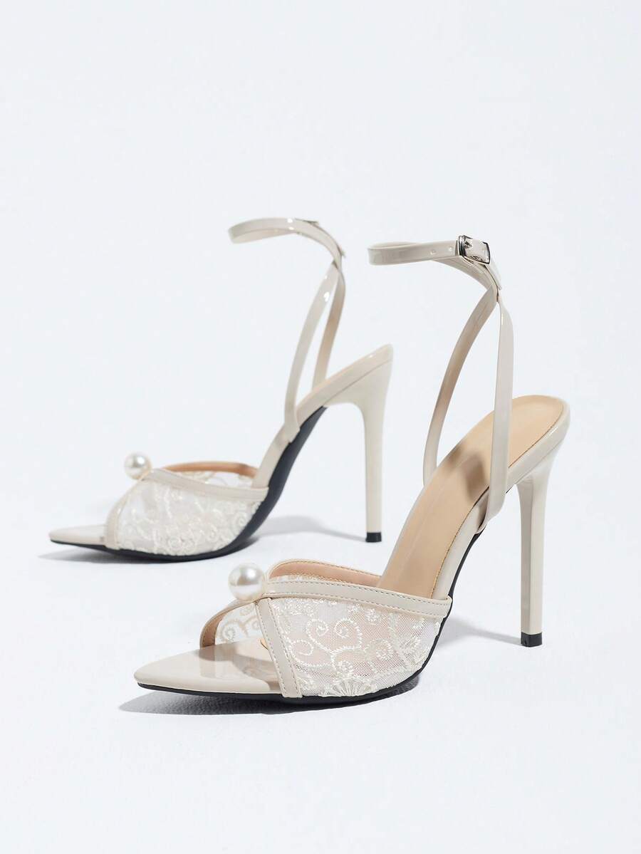 Burgundy open-toe high heels featuring an adjustable ankle strap with buckle closure and high stiletto heel.