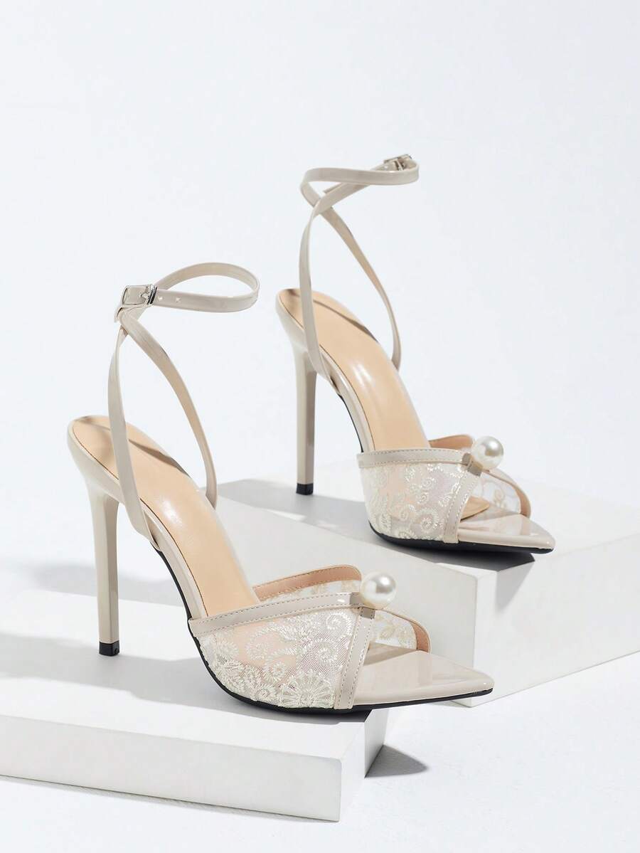 Burgundy open-toe high heels featuring an adjustable ankle strap with buckle closure and high stiletto heel.