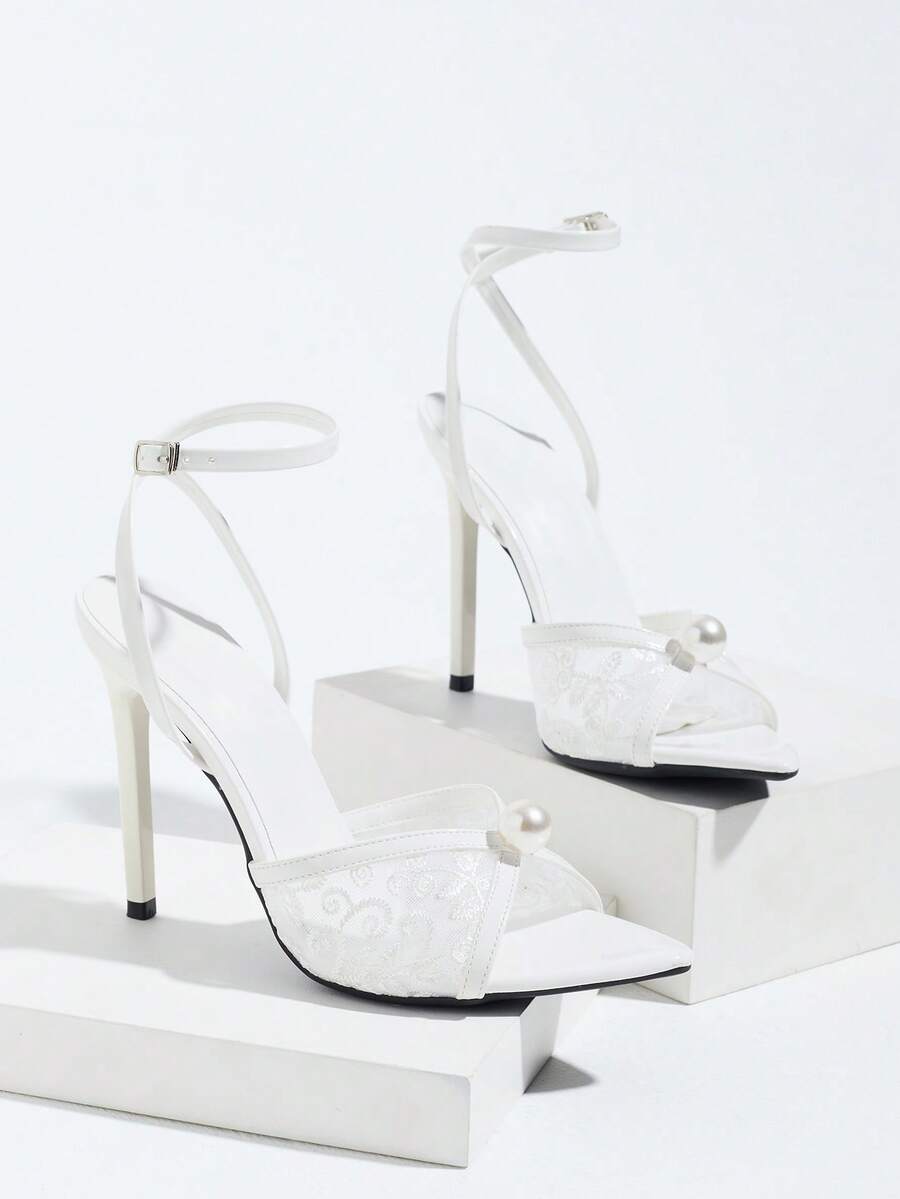 Burgundy open-toe high heels featuring an adjustable ankle strap with buckle closure and high stiletto heel.