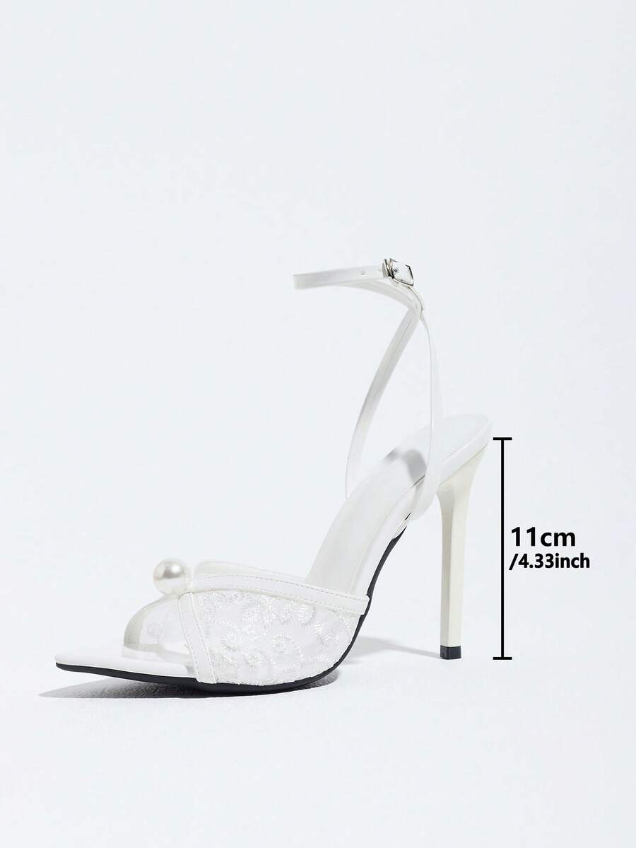 Burgundy open-toe high heels featuring an adjustable ankle strap with buckle closure and high stiletto heel.