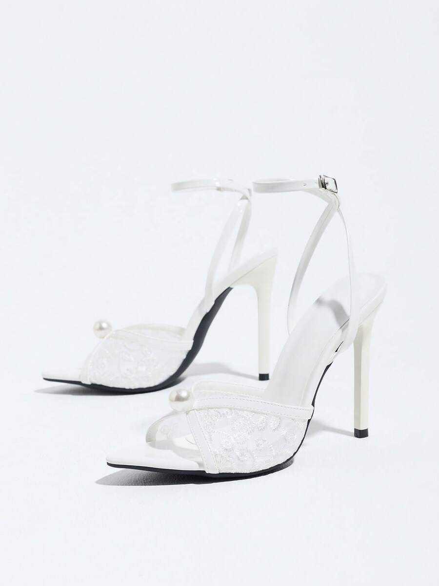 Burgundy open-toe high heels featuring an adjustable ankle strap with buckle closure and high stiletto heel.