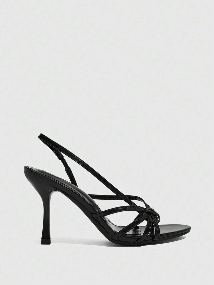 Women's open-toed stiletto high-heeled sandals in glossy patent black featuring twist strap detailing and slingback design.