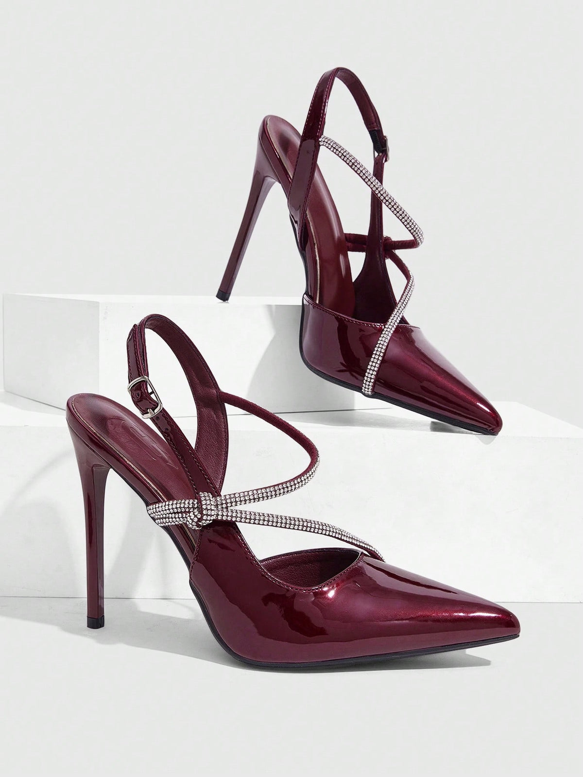 Pointed toe stiletto high heels with slingback silhouette and adjustable buckle ankle strap.