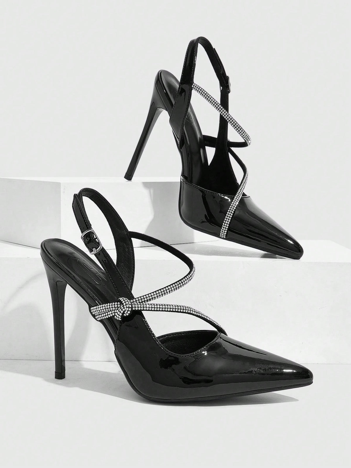 Pointed toe stiletto high heels with slingback silhouette and adjustable buckle ankle strap.