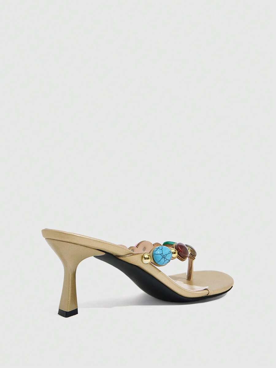 Elegant ladies strappy high-heeled slippers featuring a sleek toe post, buckle accent, and stiletto mid heel in smooth PU leather.