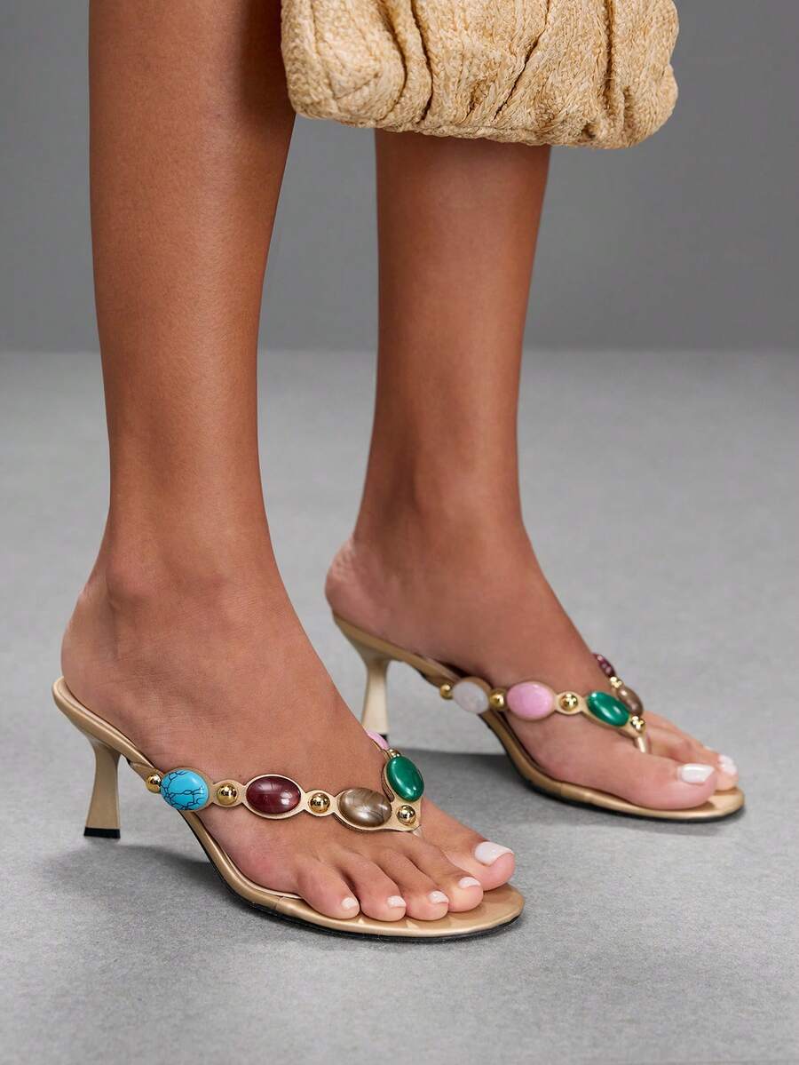 Elegant ladies strappy high-heeled slippers featuring a sleek toe post, buckle accent, and stiletto mid heel in smooth PU leather.