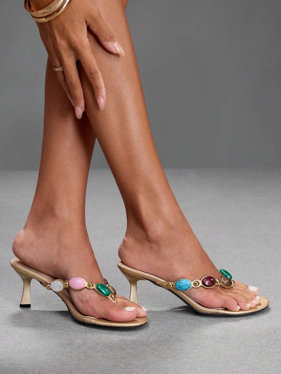 Elegant ladies strappy high-heeled slippers featuring a sleek toe post, buckle accent, and stiletto mid heel in smooth PU leather.