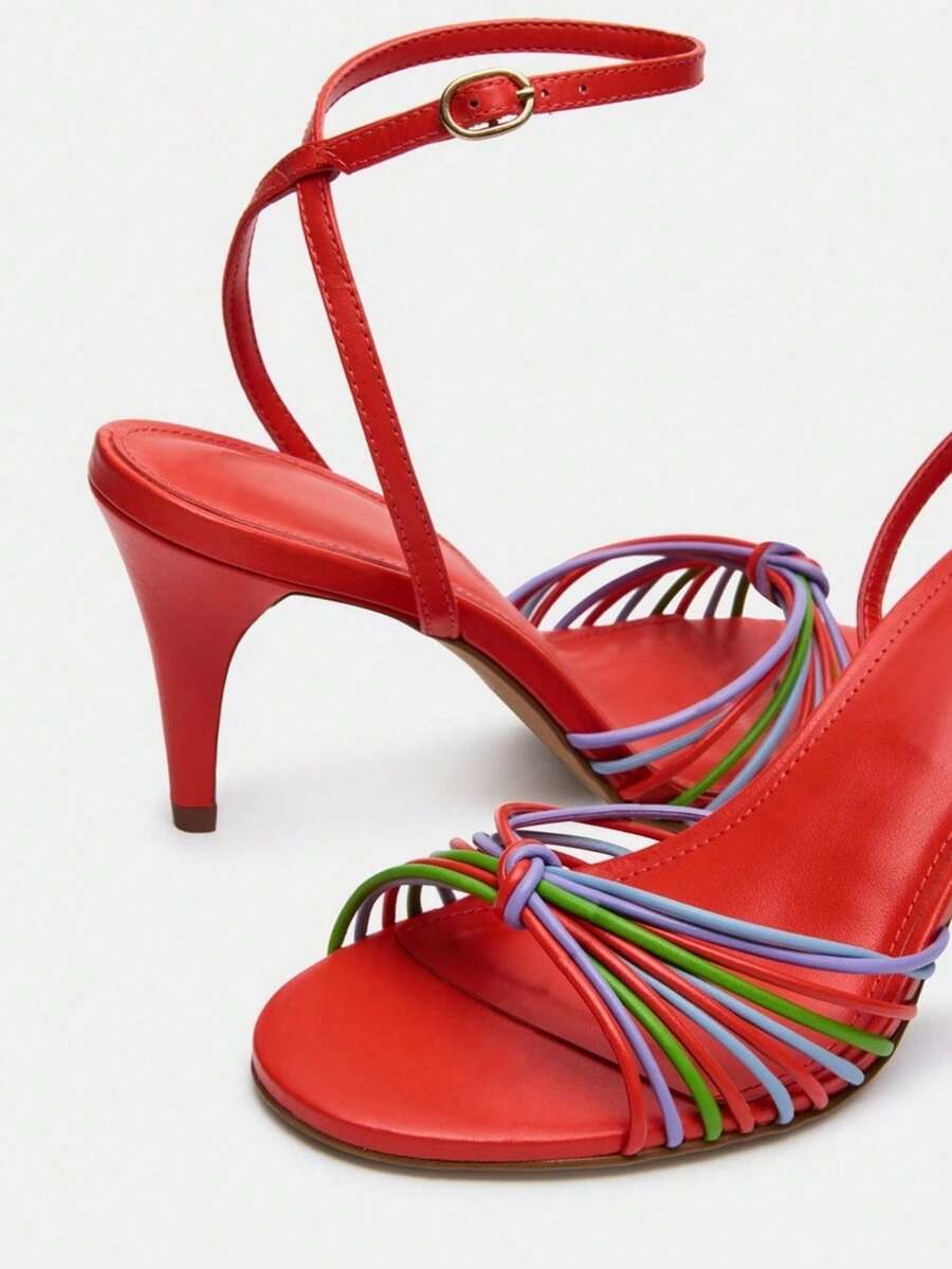 Women's open toe stiletto high heel sandals featuring metallic knot decor and an adjustable ankle buckle strap.
