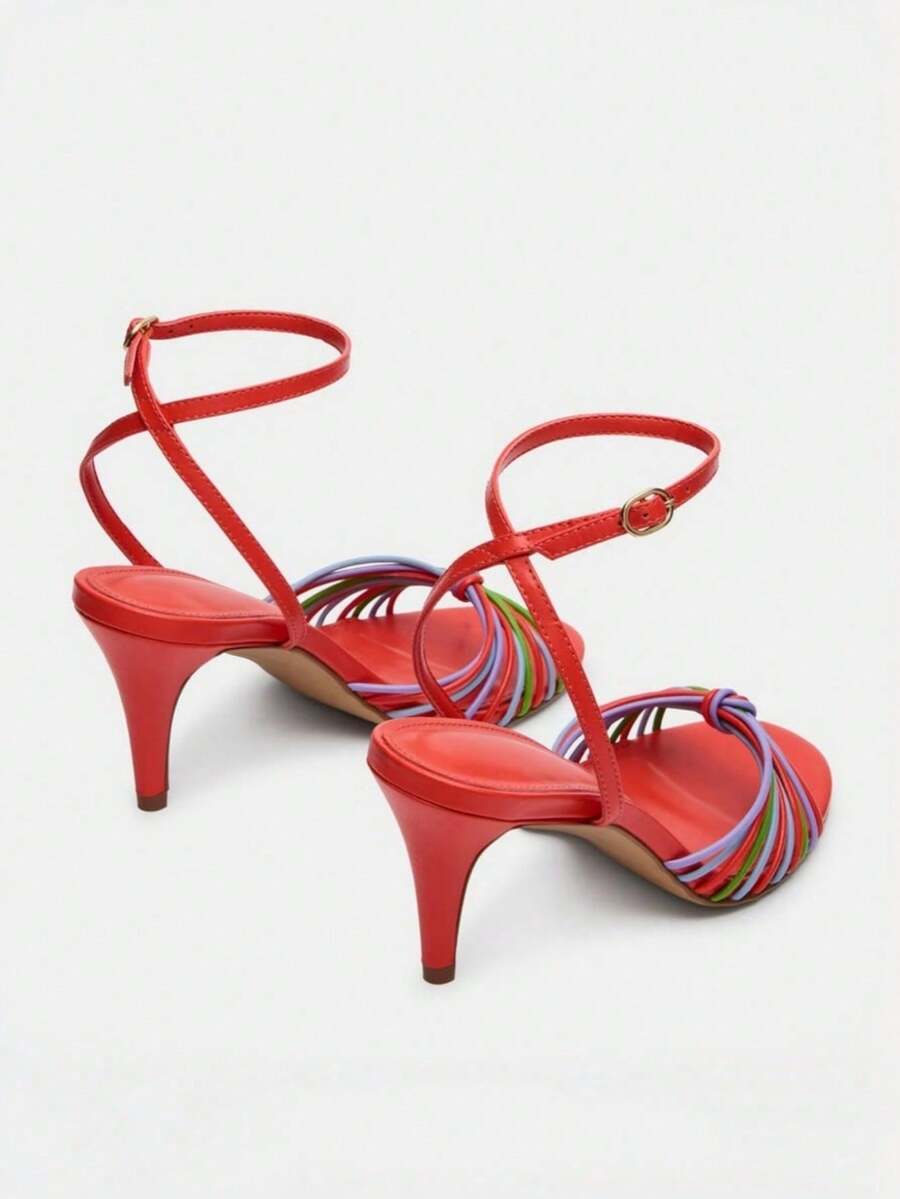 Women's open toe stiletto high heel sandals featuring metallic knot decor and an adjustable ankle buckle strap.